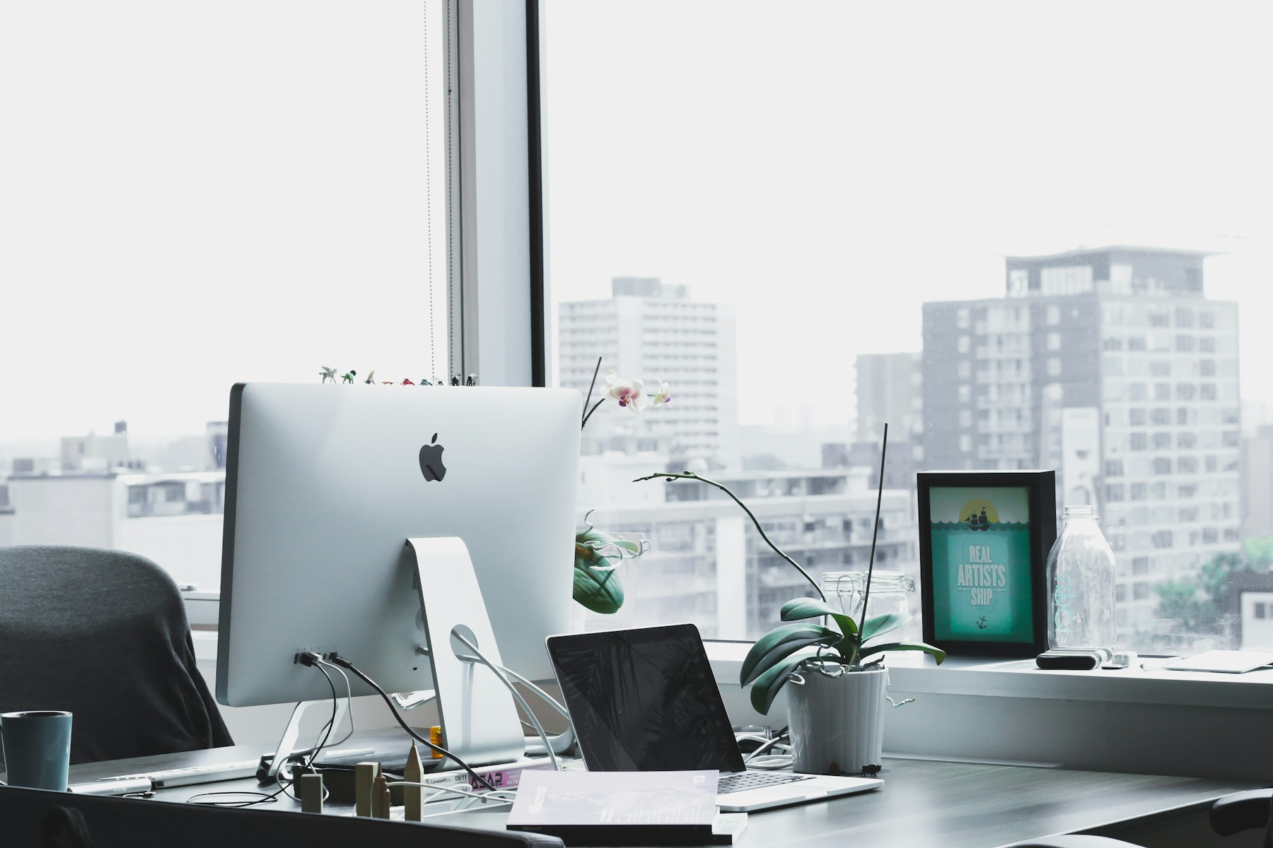 A desk by a window overlooking the city