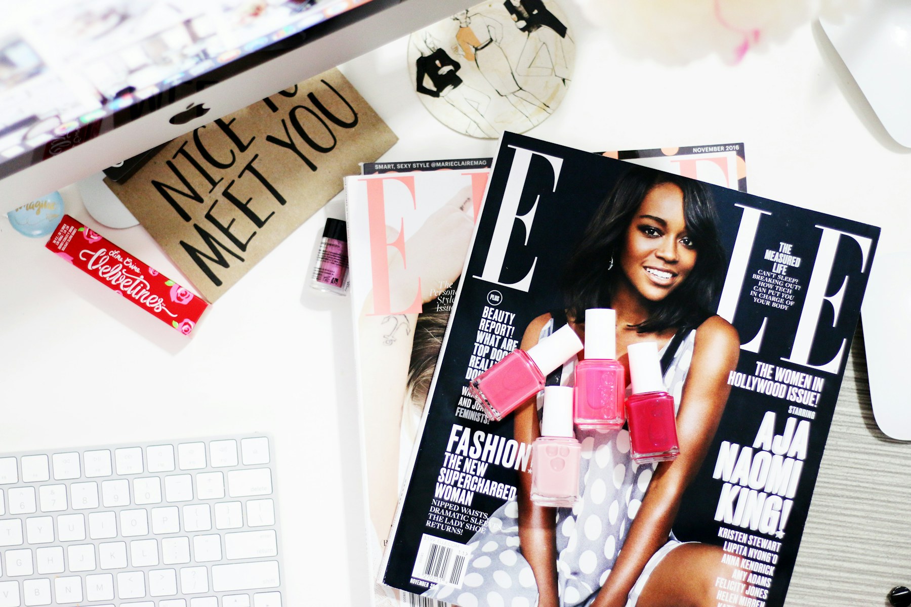Beauty magazines and nail polish on a publisher desk