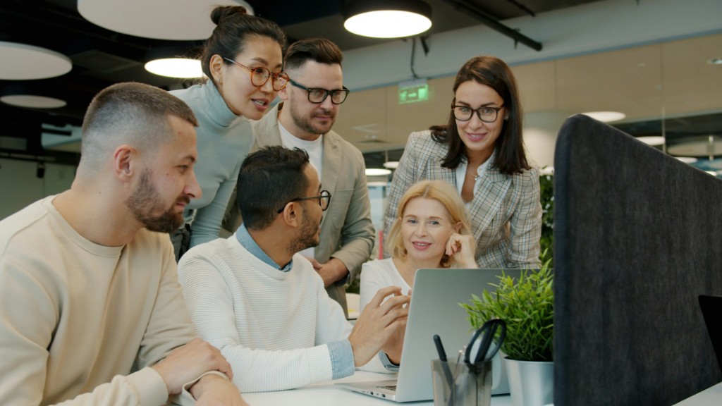 The London team collaborating around a laptop