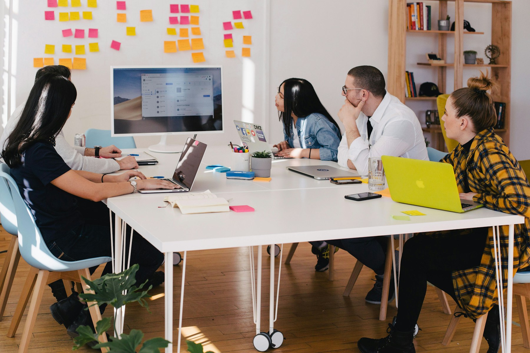 A team reviewing work together around a table